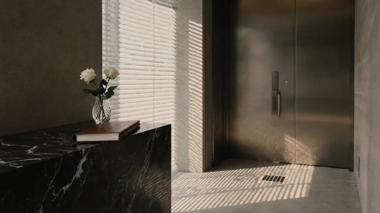 A white rose and a leather folder rest on marble in a luxury apartment lobby, conveying secrecy and discretion.