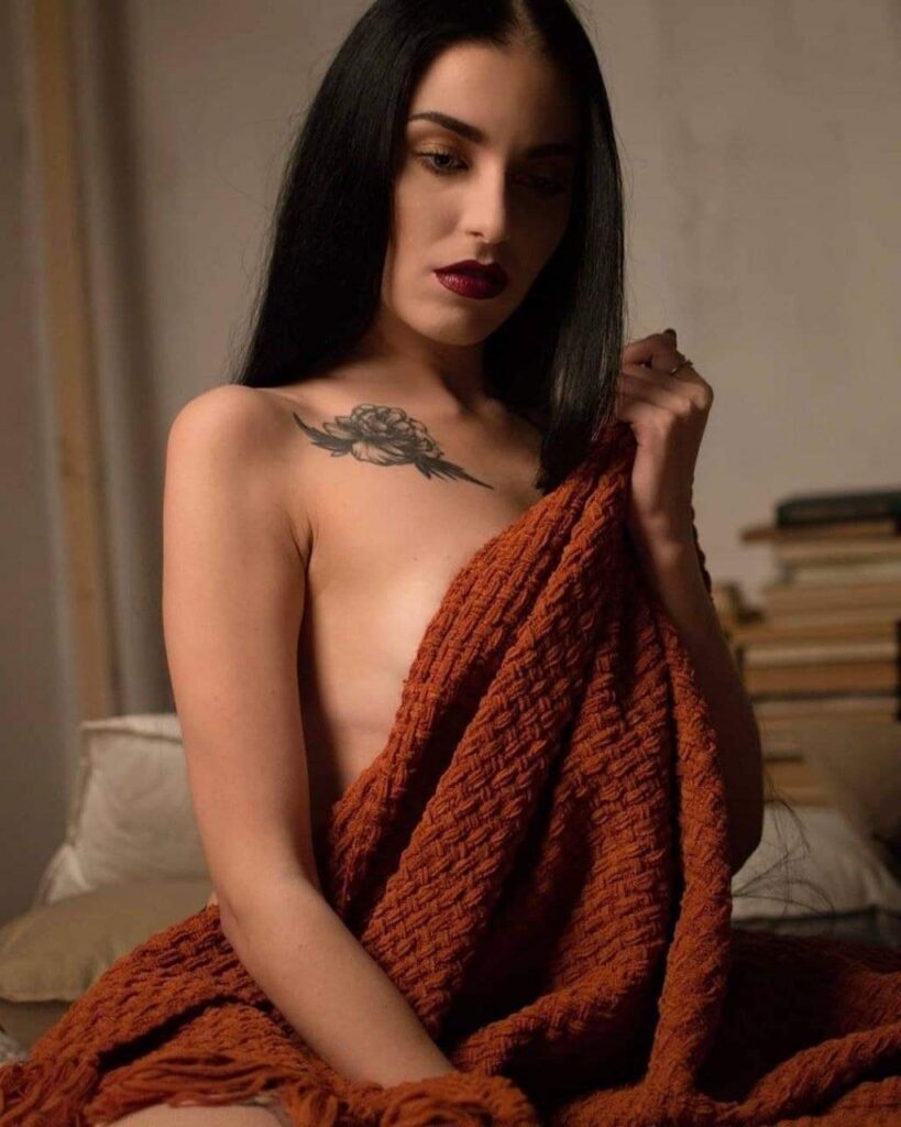 Alesya-covers-her-breasts-with-the-blanket